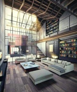 Przestronny salon z dużą biblioteką i minimalistycznym wystrojem.