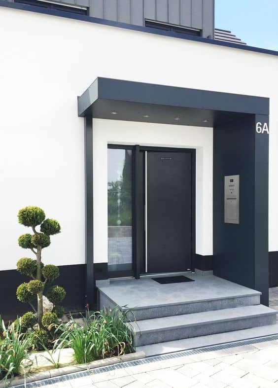 Eleganckie wejście do domu z windą i minimalistycznym designem.