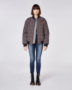 Kobieta w bomber jacket w kratkę, casual styl, modne ubranie.